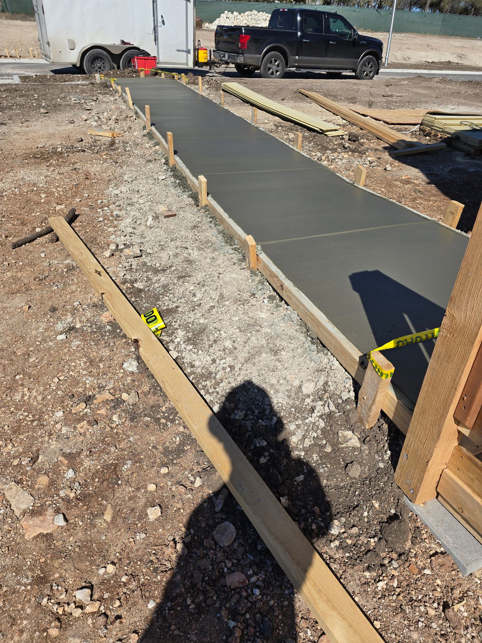 Long sidewalk pour with forms and caution tape