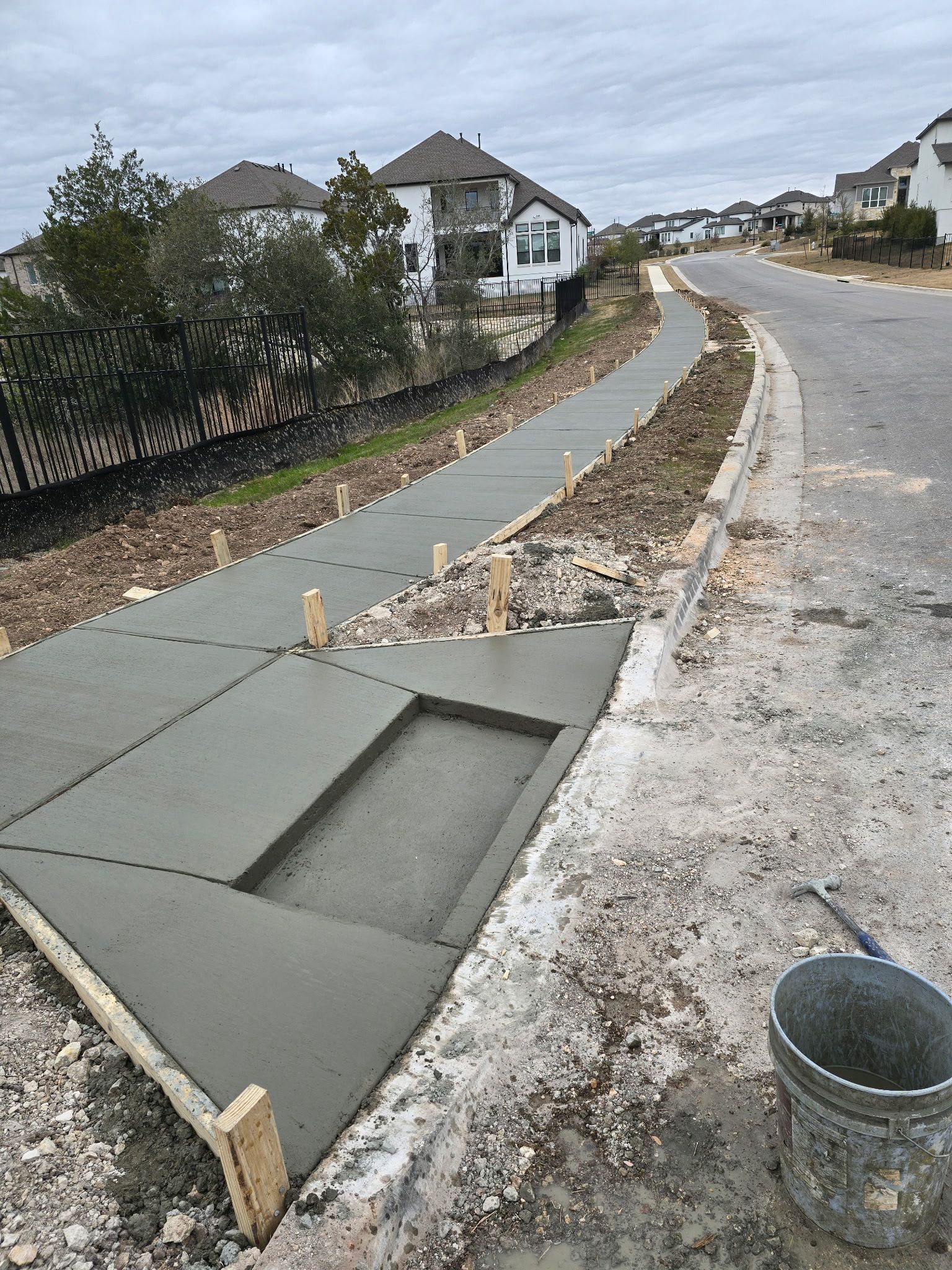 Long curved neighborhood sidewalk pour